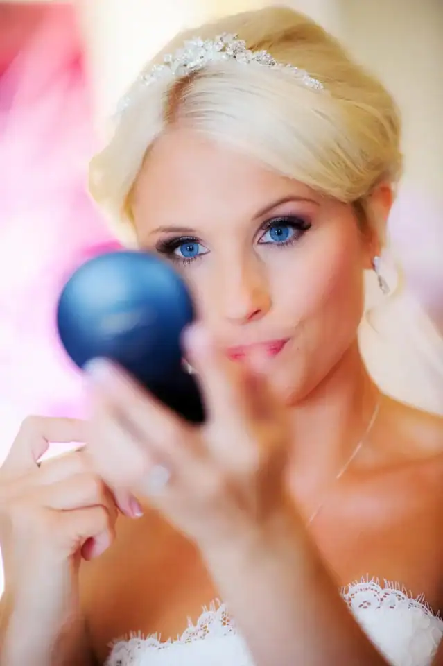 Bride touches up her makeup - Scott Gilbert Wedding Photography