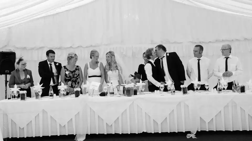 The top table share some kisses - Scott Gilbert Wedding Photography