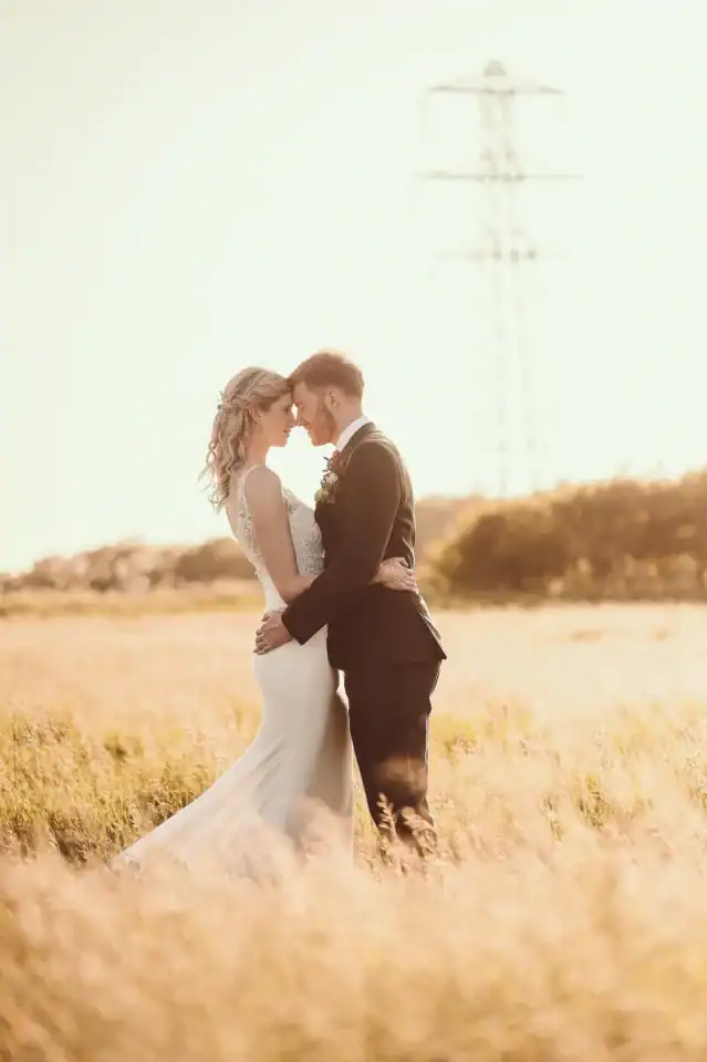 Bride and groom holding each other in Hertfordhire countryside - Scott Gilbert Wedding Photography