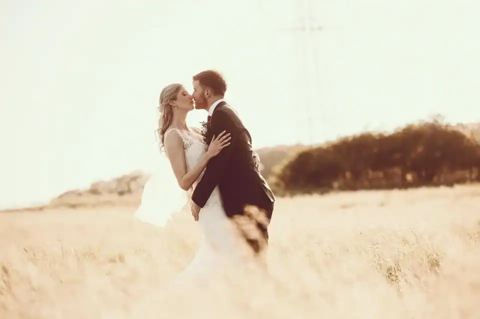 Bride and groom share a private moment in field - Scott Gilbert Wedding Photography