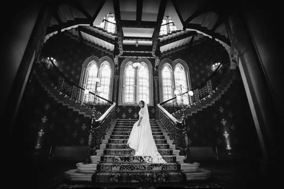 Bride walks up grand staircase at wedding venue - Scott Gilbert Wedding Photography