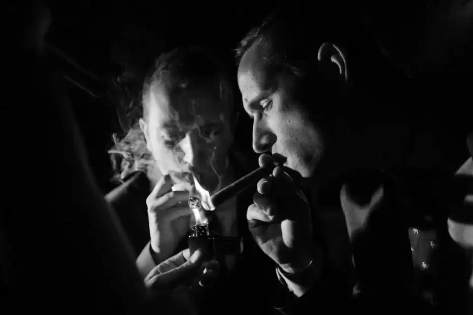 Groomsmen light a cigar to celebrate - Scott Gilbert Wedding Photography