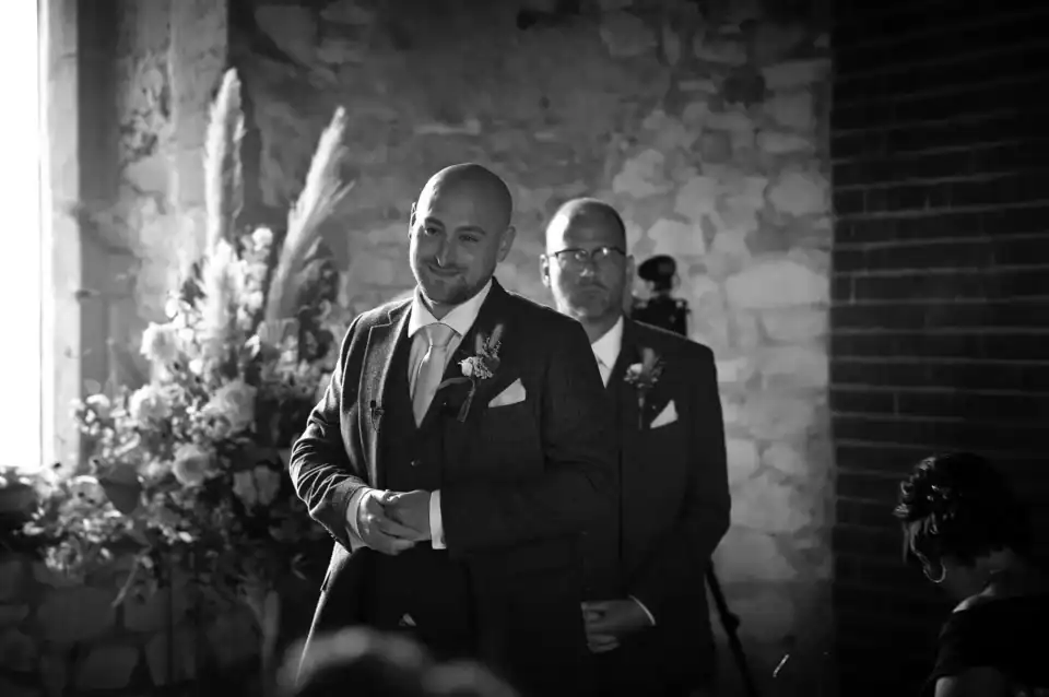 Groomsman smiling in wedding venue - Scott Gilbert Wedding Photography