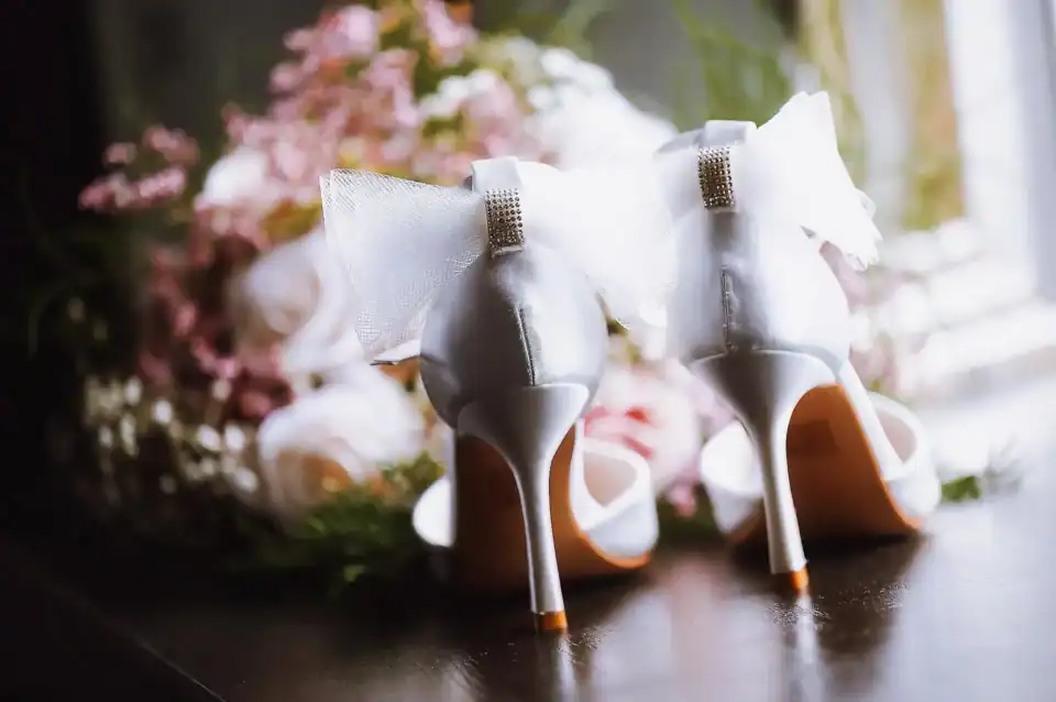 White wedding shoes with bows and crystals - Scott Gilbert Wedding Photography