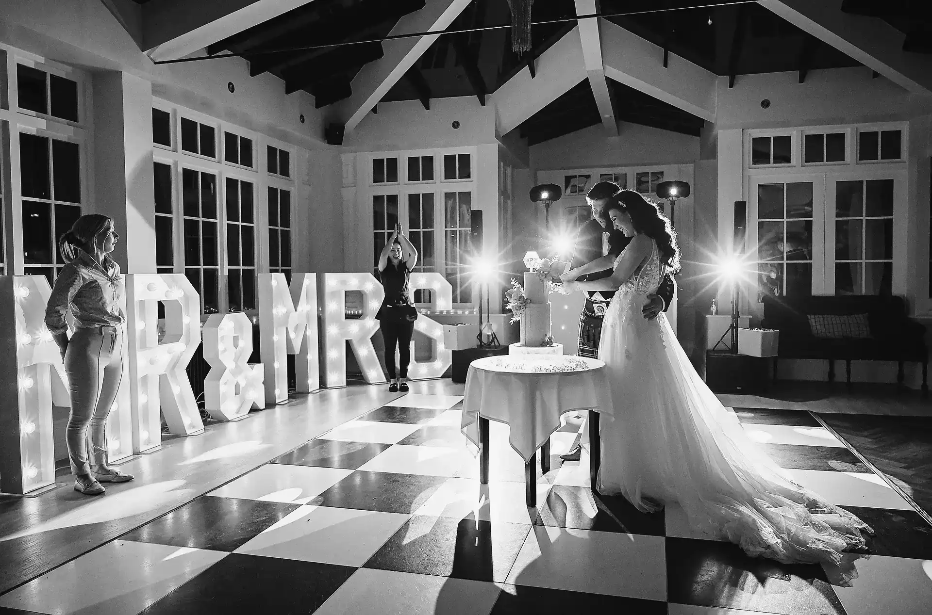 Bride and groom cut their cake at Swynford Manor wedding venue - Scott Gilbert Wedding Photography