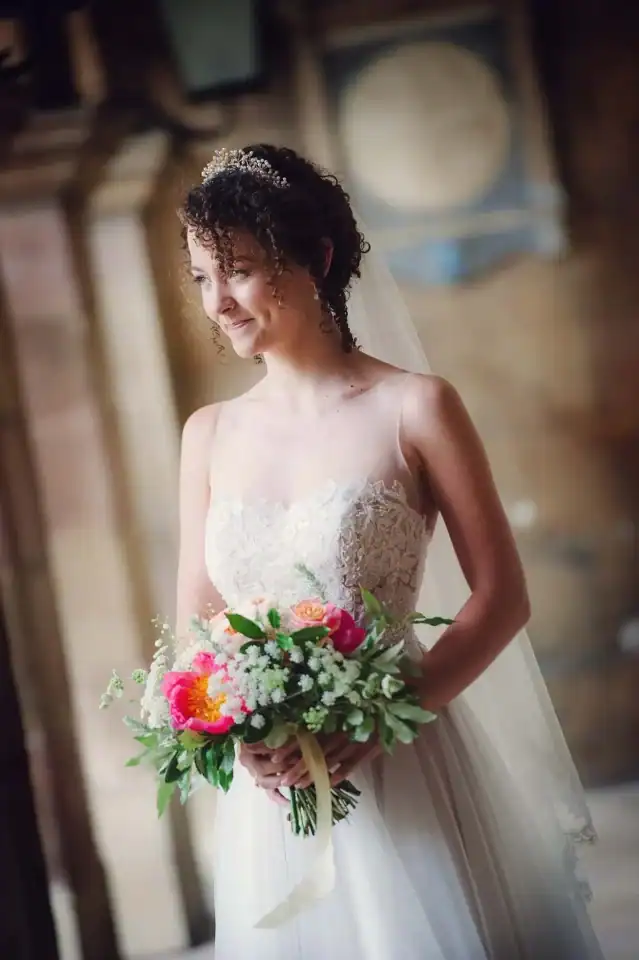 Bride holding flower bouquet in church setting - Scott Gilbert Wedding Photography