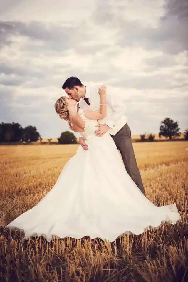 Bride and groom happy married kiss in field Cambirdgeshire - Scott Gilbert Wedding Photography