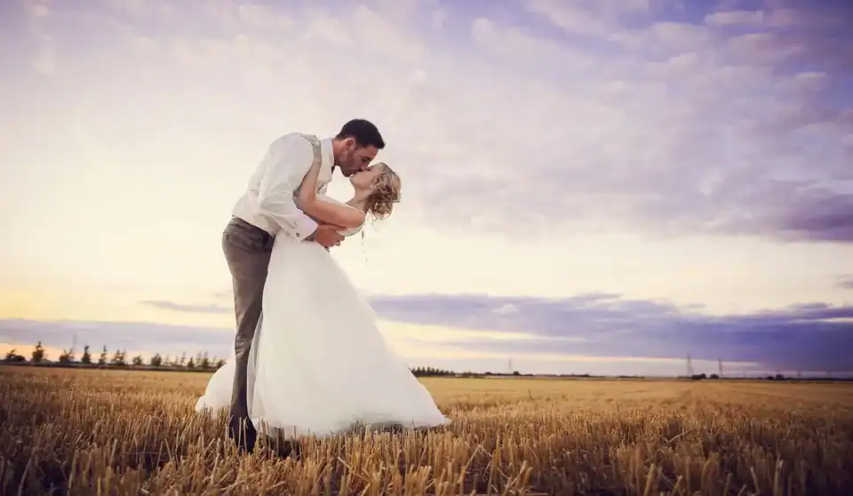 Bride and groom happy married kiss in field Cambirdgeshire - Scott Gilbert Wedding Photography
