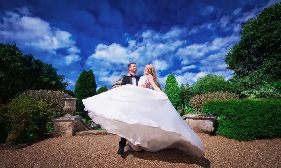 Groom and bride with white floating dress in the garden - Scott Gilbert Wedding Photography