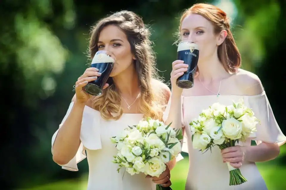 Bridesmaids drinking a pint of guiness at wedding ceremony - Scott Gilbert Wedding Photography