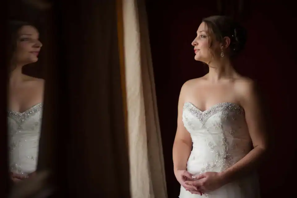 Bride looking at her reflection in white wedding dress - Scott Gilbert Wedding Photography