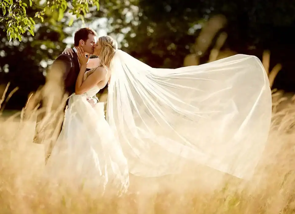 Happy married couple kissing in a corn field - Scott Gilbert Wedding Photography